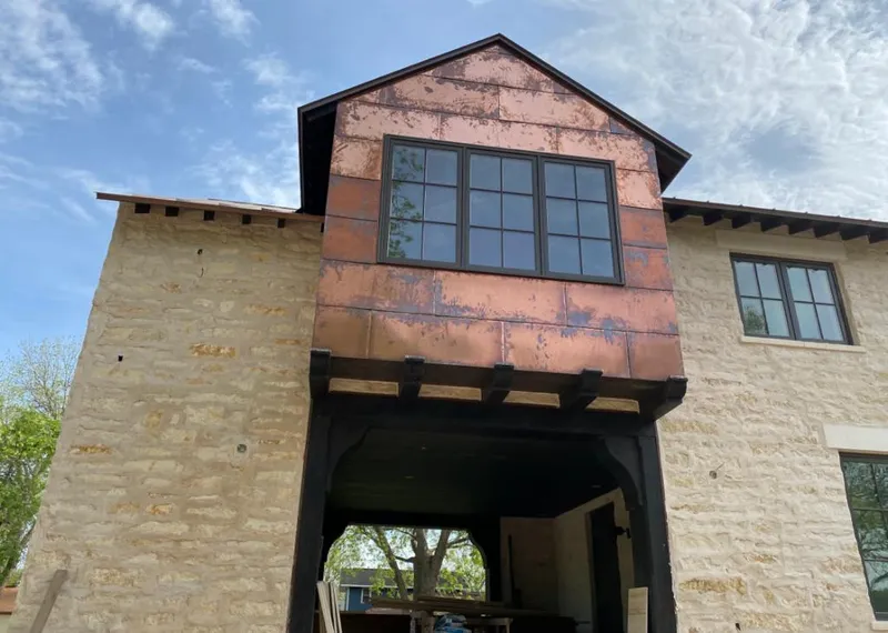 Copper metal panel facade on a stone building for Skylight Installation in Bacliff
