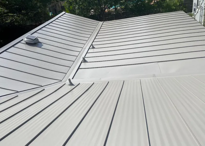 Solar attic fan installed on a metal roof for Roof Ventilation in Bacliff